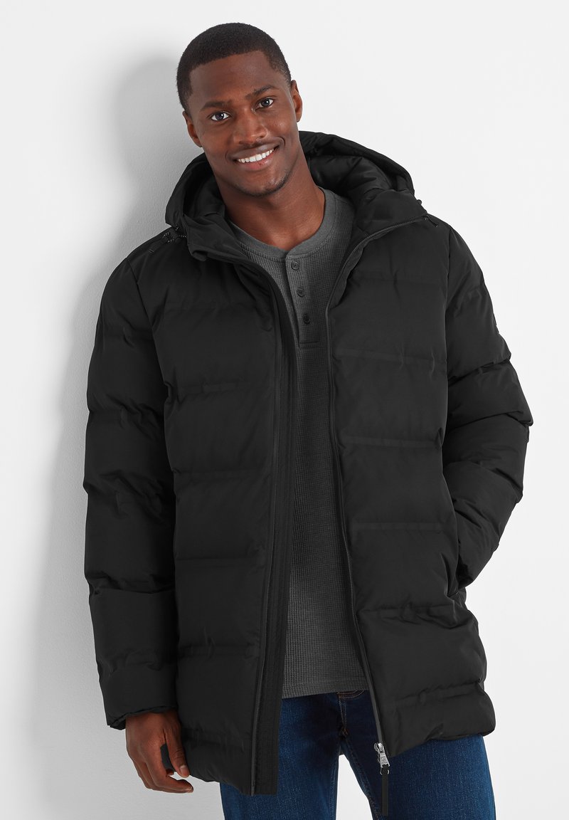 Black puffer jacket with a hood, features quilted texture, front zipper, and a warm lining, paired with a gray henley shirt underneath.