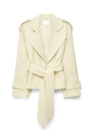 Beige cropped trench coat with wide lapels, shoulder epaulets, cuff straps, and a long tied belt at the waist on white background.