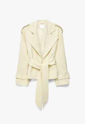 Beige cropped trench coat with wide lapels, shoulder epaulets, cuff straps, and a long tied belt at the waist on white background.