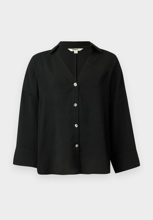 Black blouse with a V-neck, oversized fit, and three-quarter sleeves. Features metallic buttons down the front and textured fabric.