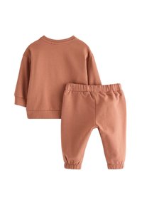 Terracotta kinderkleding bestaande uit een sweatshirt met ronde hals en joggers met elastische taille. Zachte stof met ribgebreide boorden en enkelzoom.