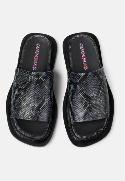 Zwarte en grijze schuifsandalen met een gestructureerd slangenleerpatroon. Voorzien van een brede band en een ronde zool. Het interieur toont een multikleuren merklogo.