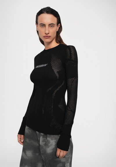 Haut noir à manches longues avec texture en maille, design côtelé et logo sur la poitrine. Présente des poignets ajustés et une silhouette moulante.