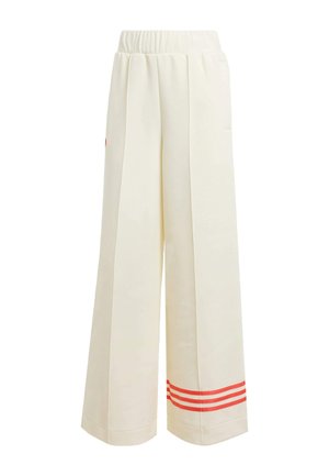 Pantalons larges crème avec une finition texturée, présentant une coupe relaxée, une taille élastique et des accents de rayures rouges à l'ourlet.