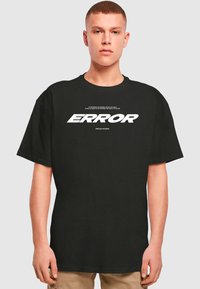 Black cotton t-shirt featuring a large white "ERROR" graphic and smaller text above. Relaxed fit with short sleeves and round neckline.