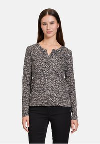 Langärmliges Hemd mit schwarz-beigem Muster und V-Ausschnitt, aus strukturiertem Stoff und mit lockerem Schnitt.