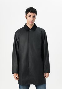 Black long coat with a collared neckline, single front button, and long sleeves. Made from a smooth, lightweight fabric. Minimalist design.