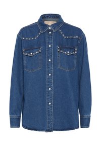 Tumši zili džinsu krekli ar garām piedurknēm, pogām ar spiedpogām, divām krūšu kabatām un izšuvumiem uz pleciem. Iespējams klasiskā apkakle.