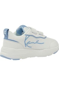 White mesh sneaker with blue accents. Features a rounded toe, adjustable straps, and textured rubber sole. Notable logo on the side.