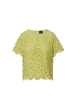 Blouse à manches courtes vert lime avec des motifs découpés, ourlet festonné et fermeture éclair au dos. Le tissu semble texturé et respirant.