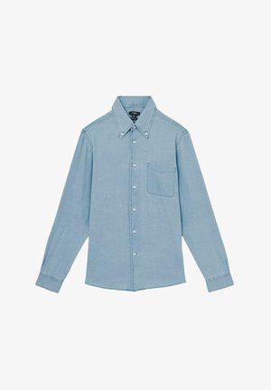 Cămașă din denim bleu deschis, cu mâneci lungi, guler cu nasturi, buzunar frontal și nasturi albi. Textură netedă, cu o croială clasică.