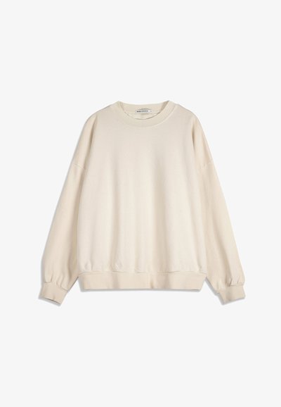 Sweat-shirt à manches longues de couleur crème avec poignets, ourlet et encolure côtelés, offrant une coupe décontractée sans motifs ni logos visibles.