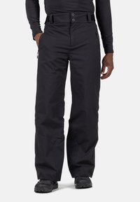 Pantaloni outdoor neri realizzati in tessuto resistente, con una vestibilità comoda, vita regolabile con cintura e tasche laterali con zip.