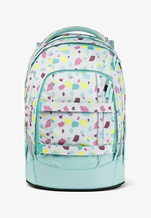 Ein Rucksack mit einem hellen Hintergrund und einem geometrischen Muster in Lila, Gelb und Türkis. Er hat gepolsterte Träger und einen robusten Boden.