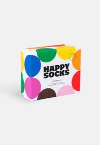 Κουτί δώρου για κάλτσες, με λευκό φόντο και μεγάλες πολύχρωμες κυκλικές σχέσεις. Κείμενο: "ΣΕΤ ΔΩΡΟΥ HAPPY SOCKS PRIDE."