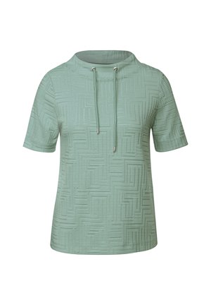 Top a maniche corte di colore verde chiaro, con un motivo geometrico testurizzato, un collo alto e dettagli con cordino.