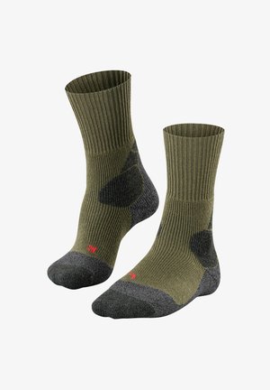Oliwkowe skarpetki o prążkowanej strukturze z ciemnoszarymi akcentami na palcach i piętach. Czerwony detal z logo po boku. Teksturalna tkanina zapewniająca trwałość i komfort.