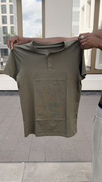 Olive green short-sleeve t-shirt made of soft fabric, featuring a round neckline with three buttons and a smooth texture.