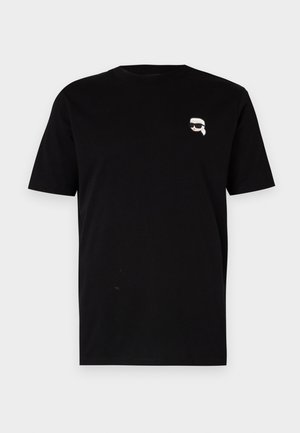 T-shirt en coton noir à manches courtes avec un petit graphique blanc d'un personnage portant des lunettes sur la poitrine gauche. Design classique à col rond.