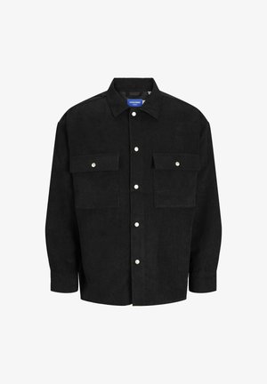 Camicia in corduroy nera con colletto a punta, due tasche sul petto e bottoni a pressione argentati. Presenta una texture a righe verticali.