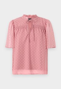 Blouse rose à pois avec des manches courtes bouffantes, un col à volants haut et une fermeture à nouer. Fabriquée en tissu transparent et texturé.