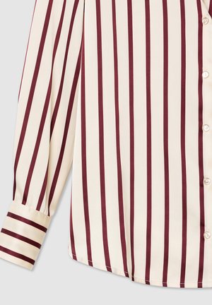 Blusa color crema con strisce verticali bordeaux, dotata di chiusura a bottoni e design delle maniche con polsini. Tessuto dalla texture liscia.