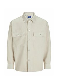 Cream-colored button-up shirt made of ribbed fabric, featuring two chest pockets with flaps and silver snap buttons. Plain collar and long sleeves.