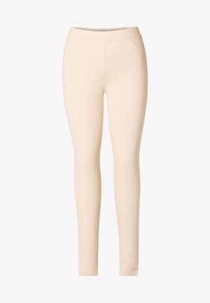 Lichtbeige leggings gemaakt van rekbare stof. Kenmerkt een gladde textuur, elastische tailleband en geen zichtbare naden of patronen.