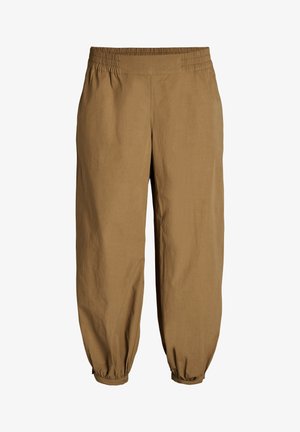 Lõdvalt istuvad pruunid püksid elastse vöökohaga ja kogutud elastsete suuotsadega pahkluu juures, mõeldud igapäevaseks kandmiseks.