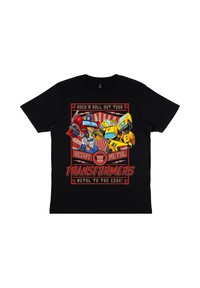 Černé tričko s barevným grafickým potiskem postav z Transformers, textem "Rock 'N Roll Out Tour" a "Metal to the Core!" v tučných písmenech.