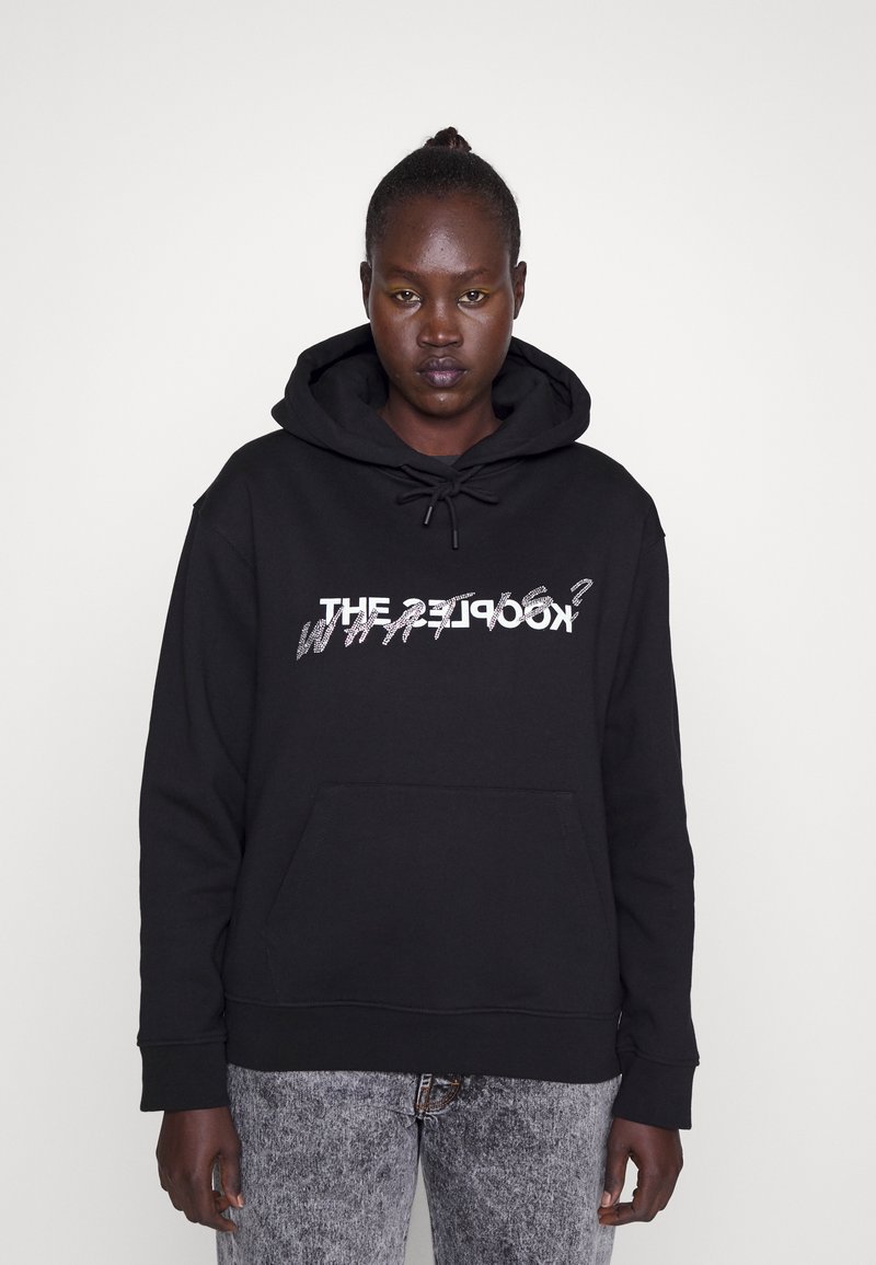 Black hoodie with drawstring hood, featuring a white graphic text design on the front. Material is soft, with a front pocket and ribbed cuffs.
