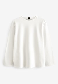 Camicia bianca a maniche lunghe in morbido cotone. Presenta un collo tondo, vestibilità comoda e orlo dritto con leggeri spacchi laterali.