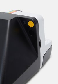 Instant camera with a black body, white accents, yellow power button, USB-C port, and rainbow detail on top. Smooth, modern design.