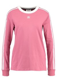 Långärmad rosa bomullströja med vit krage och tre vita ränder längs varje ärm; har en liten vit logotyp på bröstet.