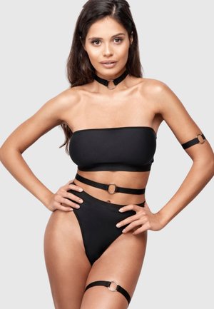Black bandeau bikini top with matching high-waisted bottoms, featuring sleek straps and metal ring accents. Smooth, stretchy material.