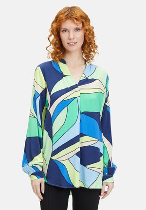 Mehrfarbige, langärmelige Bluse in Blau, Grün und Creme mit einem geometrischen Blättermuster; verfügt über einen V-Ausschnitt und geraffte Bündchen.