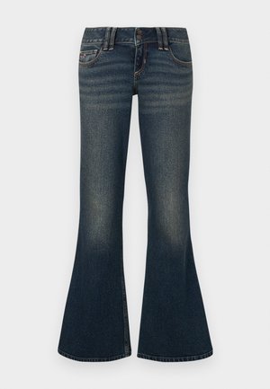 Σκούρα μπλε τζιν καμπάνα από denim, με κλείσιμο δύο κουμπιών, διακριτική ξεθώριαση και κλασικό ράψιμο κατά μήκος των τσεπών και των ραφών.