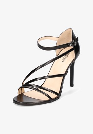 Sandales à talons hauts noires à brides fines avec boucle à la cheville. Présente une pointe effilée et une texture lisse et brillante.