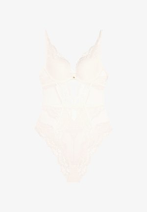 Weißer Spitzen-Bodysuit mit transparenten Details, Unterbrustschalen, gewellten Kanten und einem kleinen goldenen Herzakzent an der Vorderseite.