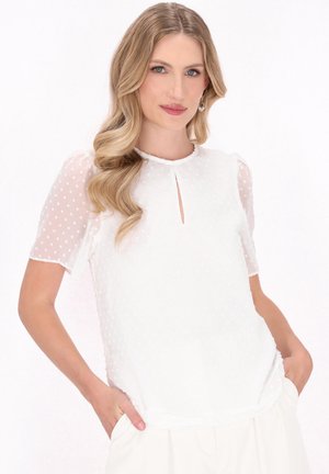 Weiße Bluse mit kurzen, durchsichtigen Puffärmelchen, strukturiert mit kleinen Punkten, ausgestattet mit einem Schlüsselloch-Ausschnitt und weichem, fließendem Stoff.
