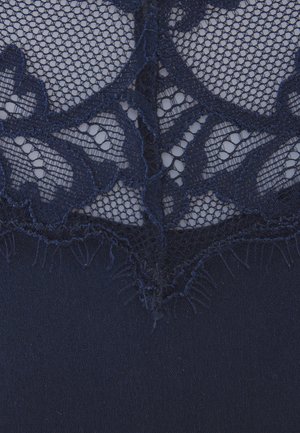 Navy blue fabric featuring intricate lace with floral patterns, textured edges, and a smooth base layer. Lace has a delicate, open weave.