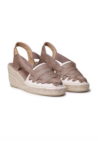 Brown woven espadrille wedges with a beige fabric base, featuring a soft texture and a raised rope sole. Slingback design with wide straps.