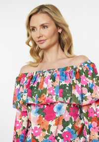 Blomsterdesign off-shoulder top med livlige pink, blå og grønne farver, med flæser på ærmerne og et let stof.