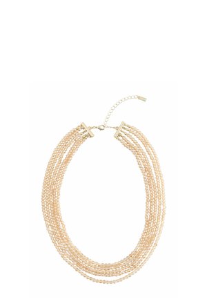 Multi-strand beige pearl necklace with gold clasp and adjustable chain extender on white background.