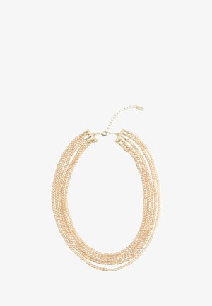 Multi-strand beige pearl necklace with gold clasp and adjustable chain extender on white background.