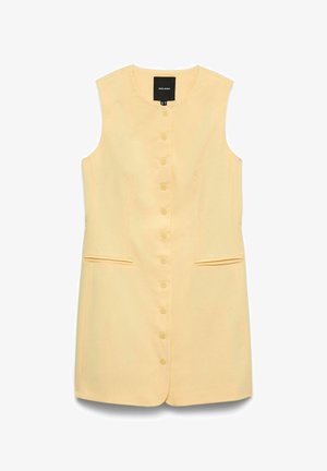 Robe sans manches jaune pâle à boutons, avec col rond, deux poches fendues à l'avant, et une étiquette noire à l'intérieur du col.