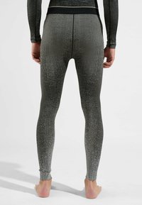 Graue Ripp-Leggings mit einem schwarzen Bund, enganliegendem Schnitt und texturiertem Finish. Der Stoff hat einen leichten Glanz.