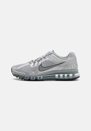 Gray athletic shoe with mesh upper, black swoosh logo, and transparent air cushioning sole. Features round laces and padded collar.