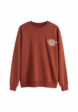 Mikina s dlhým rukávom vo farbe hrdzavej, s rebrovanými manžetami a lemom, s malým bielym logom "Fleetwood Mac" na ľavej strane hrudníka.