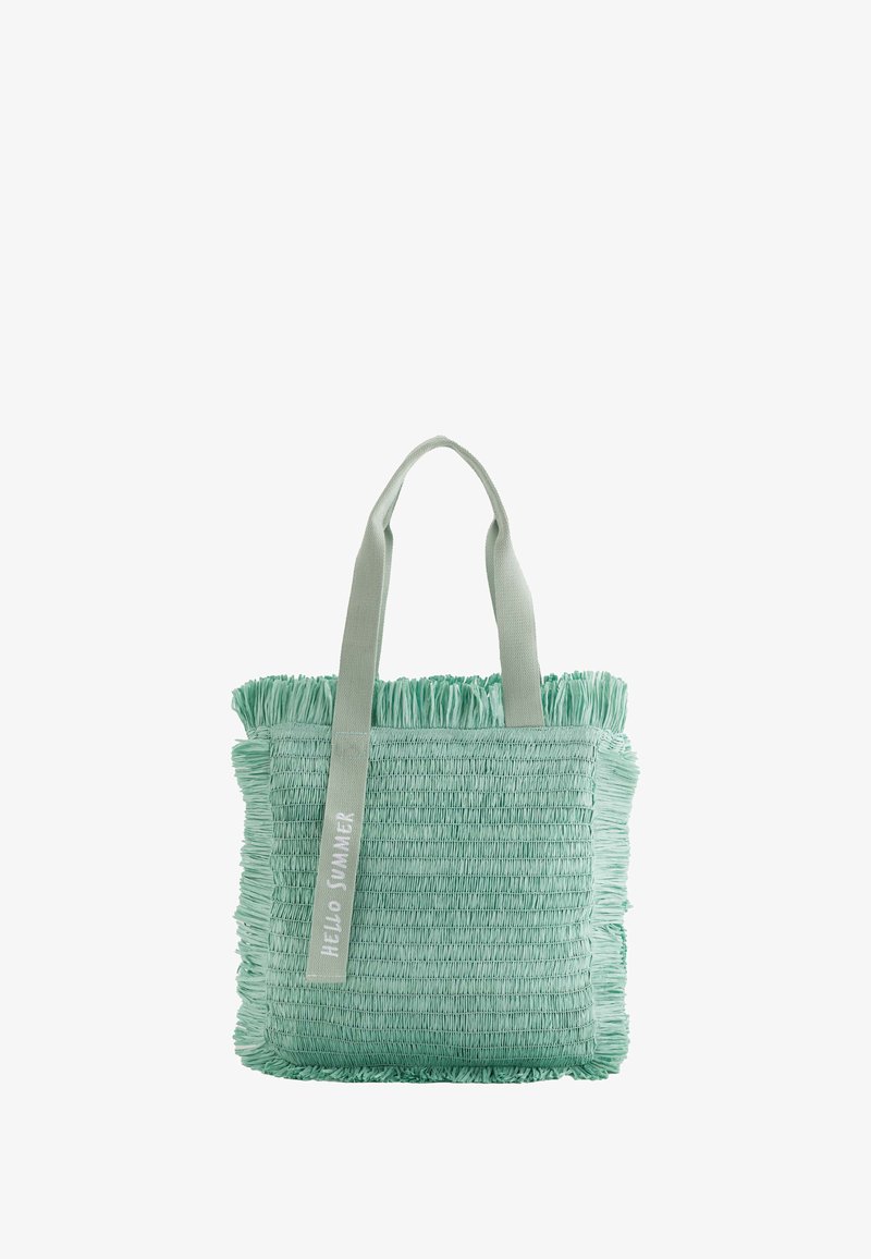 Mint green tote bag made of textured woven material, featuring fringed edges and two fabric handles with "HELLO SUMMER" print.
